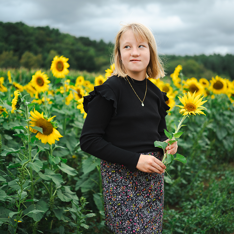 Girl looking off into the distance during a family photography session